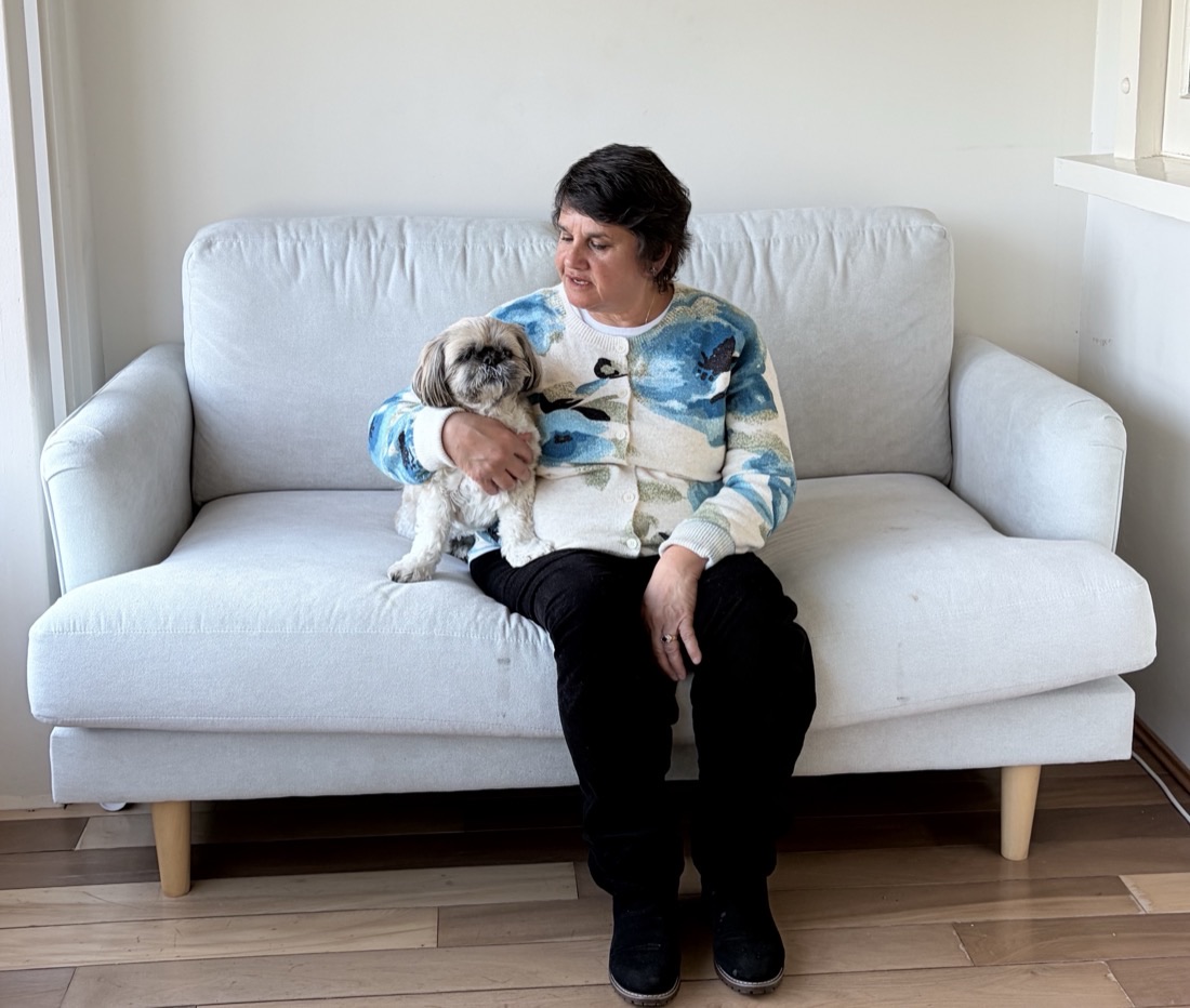 Jackie Nugara sitting on a sofa with her dog