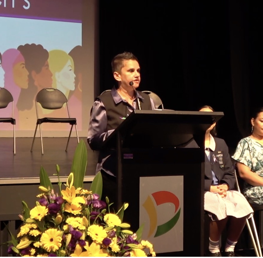 Jackie Nugara delivering a keynote at a podium