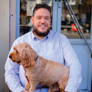 Man smiling holding his dog